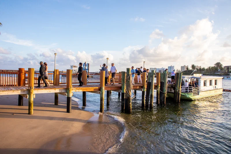 Guests walking along the lighthouse dock after arriving by tour boat